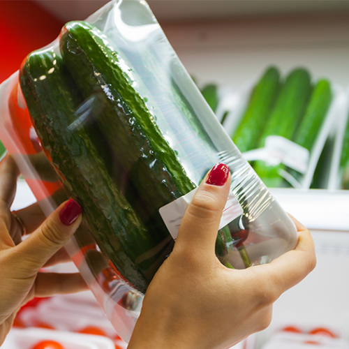 two-cucumbers-packed-in-plastic-film-on-white-foam-tray-in-supermarket